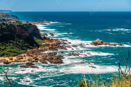 A view from West Head headland of the rocky coastline on East Head headland at the mouth of the Knysna river , South Africa in Springtime