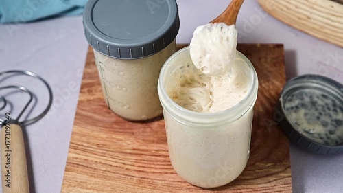 Fresh leaven sourdough starter in glass jars, bright background