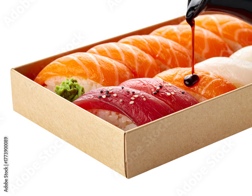  Sushi Bento Box Close-Up with Drizzling Soy Sauce, angled side view, isolated
