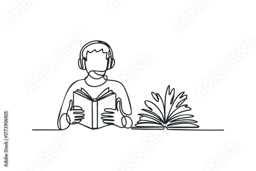 Person wearing headphones reads an open book