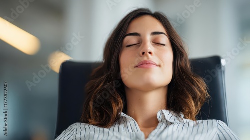 Corporate leader woman with closed eyes and relaxed face in office chair