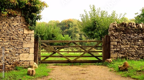 Wooden country gate in the rural English Cotswolds. Cotswolds countryside, England