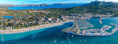 Aerial Sunrise Over Alcúdia Bay: Water front Resorts and Hotels over look the Beach, and Port in Mallorca, Spain