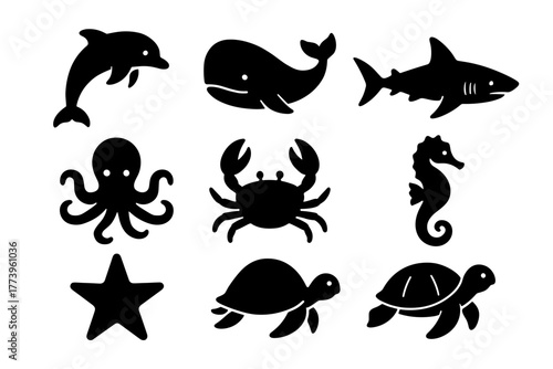 Set of black pixel art silhouettes of ocean creatures including dolphin whale shark octopus crab seahorse starfish and sea turtle on white background