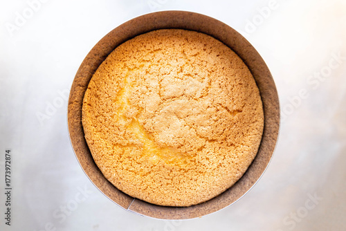 stylish flatlay of golden sponge cake, sophisticated flatlay showcasing golden crumb sponge cake in paper mold