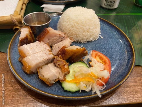 Lechon Kawali, a Filipino dish of fried belly pork served with rice and a salad garnish