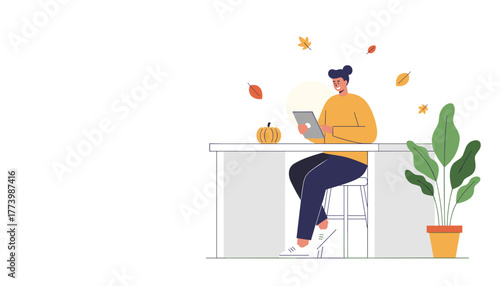 Cozy autumn remote work or studying concept Person sits at counter using a digital tablet