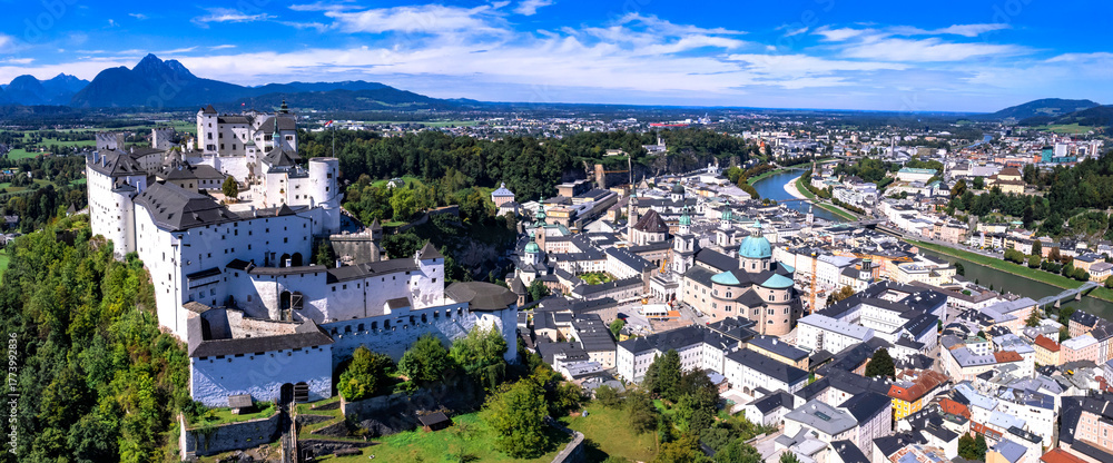 Fototapeta premium Salzburg - iconic town and great historic landmarks of Austria. aerial drone high agle view of old city with Hohensalzburg fortress and Salzach river