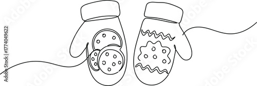 Winter mittens decorated with cookies and festive patterns  