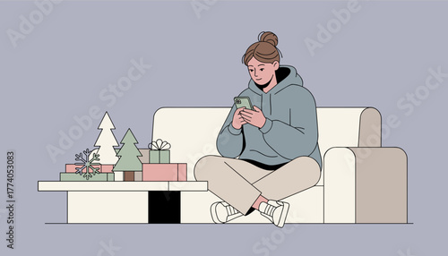 Woman relaxing on a couch using a smartphone during the winter holiday season