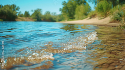 Realistic serene photo of gentle waves rippling on a clear blue pond in a calm desert oasis, golden sand glistening, distant lush greenery, evoking peace, mindfulness, and minimalist color harmony.