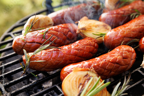 Grilled sausages on grill, close up view