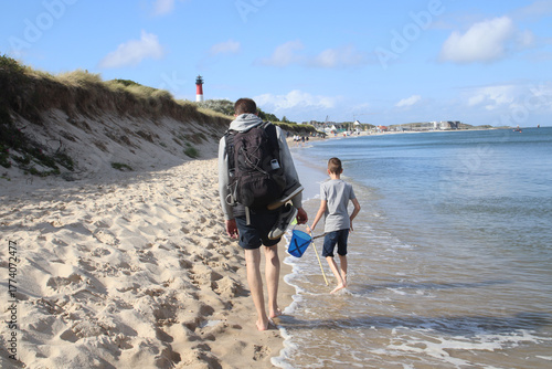 Rear view of a family walking on the beach in Hörnum on the island of Sylt