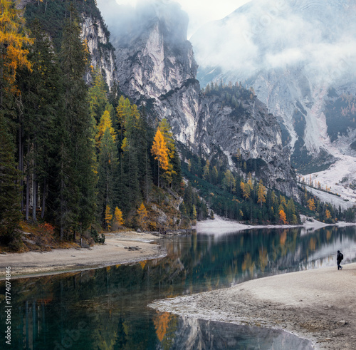 Landscape with high rocky mountains covered with forests. Mountain clear lake Lake Braies, Dolomites, Italy. Autumn landscape.