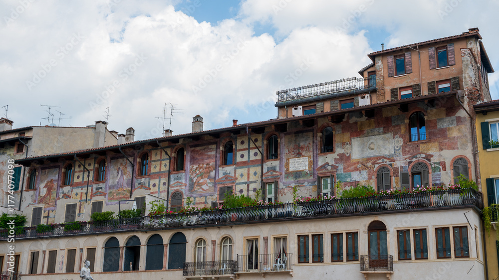 Obraz premium The historic Case Mazzanti in Verona Italy featuring a multi-story facade covered in faded 16th-century frescoes