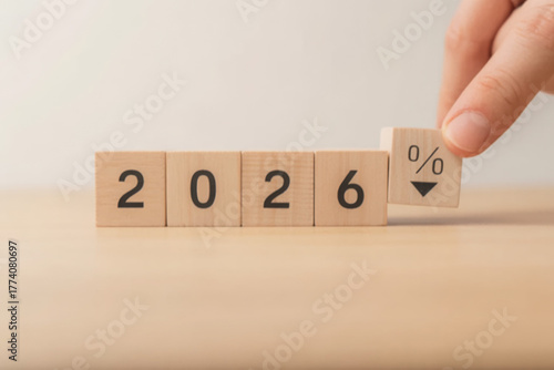Wooden blocks showing the year 2026 with a percentage sign pointing down suggesting a decrease or reduction business forecast concept