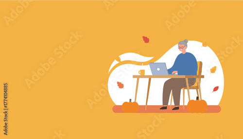 Elderly woman working on laptop at cozy autumn desk with pumpkins and falling leaves