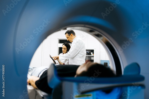 фотографія Medical professionals, a male doctor and female technician, are collaborating in