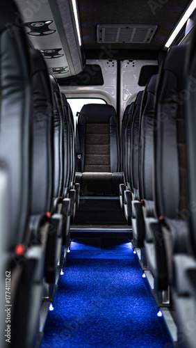 Modern bus interior with clean, comfortable seats arranged in rows. The image captures a bright and tidy passenger cabin, ideal for illustrating public transportation, travel comfort, tourism.