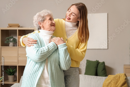 Senior woman hugging her gr...