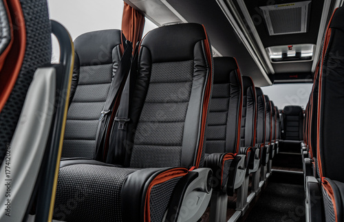 Simple bus interior with clean seats and red design details. Minimal yet functional layout creating a neat, modern, and comfortable atmosphere for everyday travel or transport.