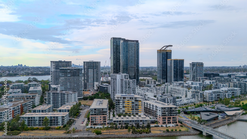 Fototapeta premium Aerial Drone View of Wentworth Point and Rhodes a suburb in western Sydney newly built residential high rise apartments area on Parramatta River Sydney NSW Australia