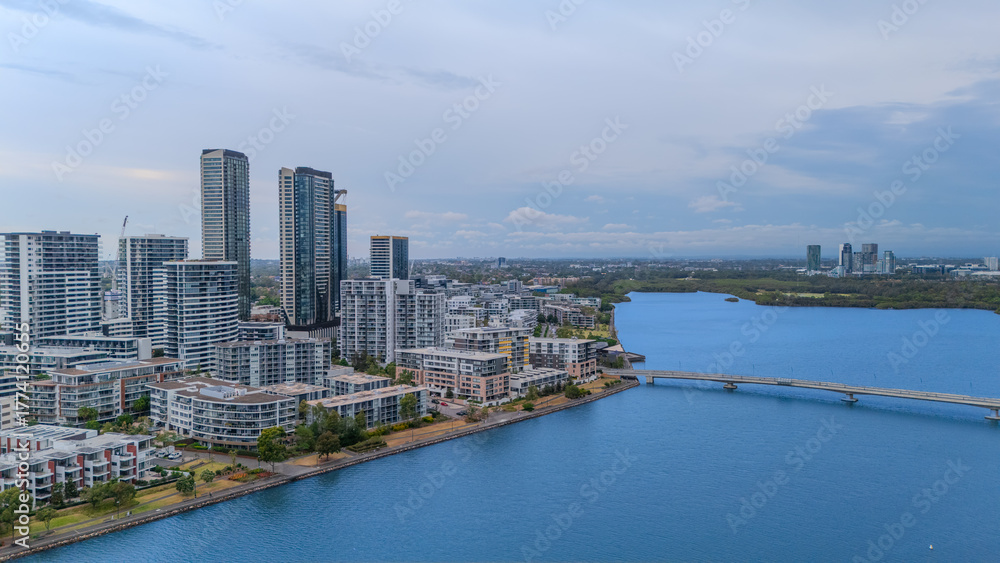 Obraz premium Aerial Drone View of Wentworth Point and Rhodes a suburb in western Sydney newly built residential high rise apartments area on Parramatta River Sydney NSW Australia