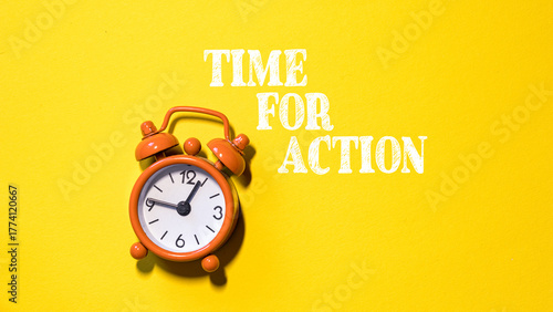 Photography A orange alarm clock with the words Time for Action
