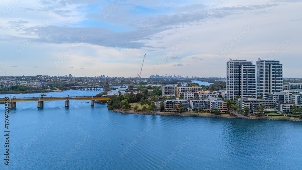 Obraz premium Aerial Drone View of Wentworth Point and Rhodes a suburb in western Sydney newly built residential high rise apartments area on Parramatta River Sydney NSW Australia