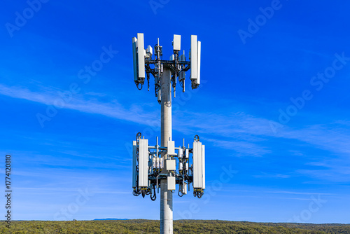 Drone aerial photograph of the top section of a large Cellular Tower against a bright blue sky background in the Blue Mountains, New South Wales, Australia.