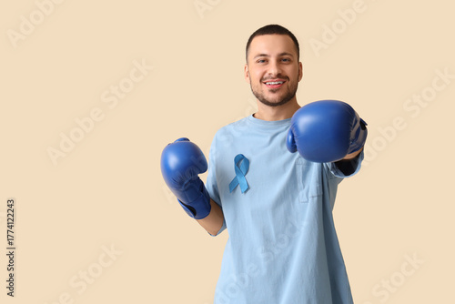 Young man in boxing gloves ...
