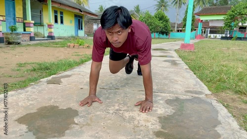 A young handsome man doing mounting climber exercise on a terrace