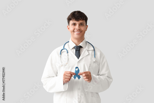 Male doctor with blue ribbo...