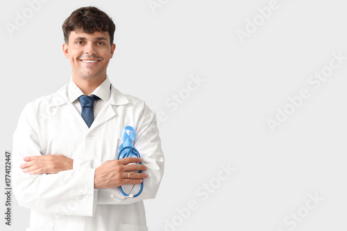 Male doctor with blue ribbo...