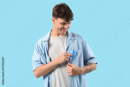 Young man with blue ribbon ...