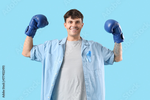 Young man in boxing gloves ...