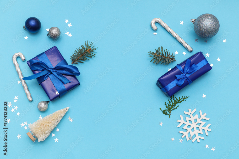 Obraz premium Festive composition with gift boxes and Christmas decorations on blue background