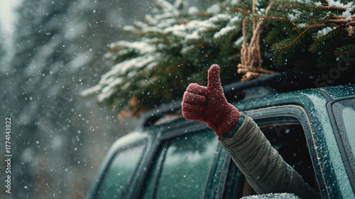 A deep green SUV drives through a snow-covered landscape, with a fully loaded roof featuring a fresh Christmas tree. A cheerful thumb's up gesture adds a joyful touch to the winter scene