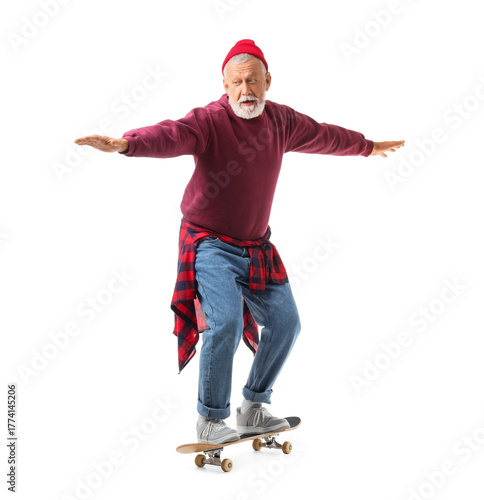 Senior man riding skateboar...