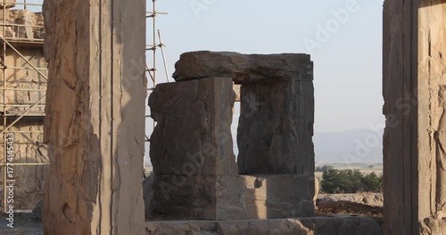 Warm light grazes a Persepolis doorway where a carved Achaemenid figure stands on a stone pillar. Weathered textures, open frame, and desert calm evoke endurance, memory, and timeless ritual.
