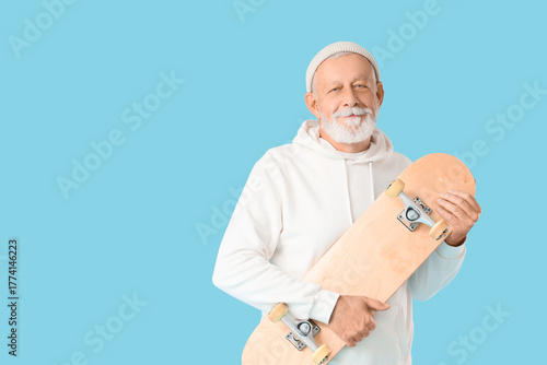 Senior man with skateboard ...