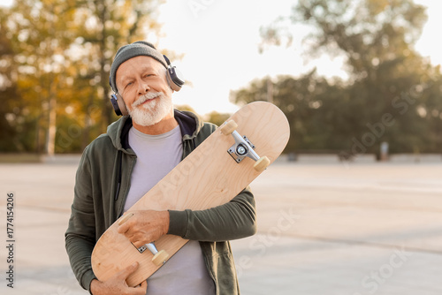 Happy senior man in headpho...