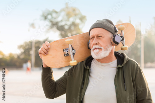 Senior man in headphones wi...