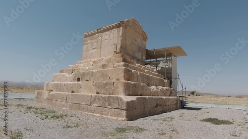 Wallpaper Mural Frontal view of the Tomb of Cyrus the Great in Pasargadae, Iran—stepped limestone platform beneath a cloudless sky. Historic Achaemenid monument with a serene desert atmosphere. Torontodigital.ca