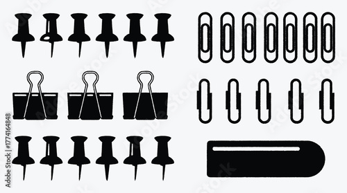 Black and white office supplies arrangement with push pins binder clips