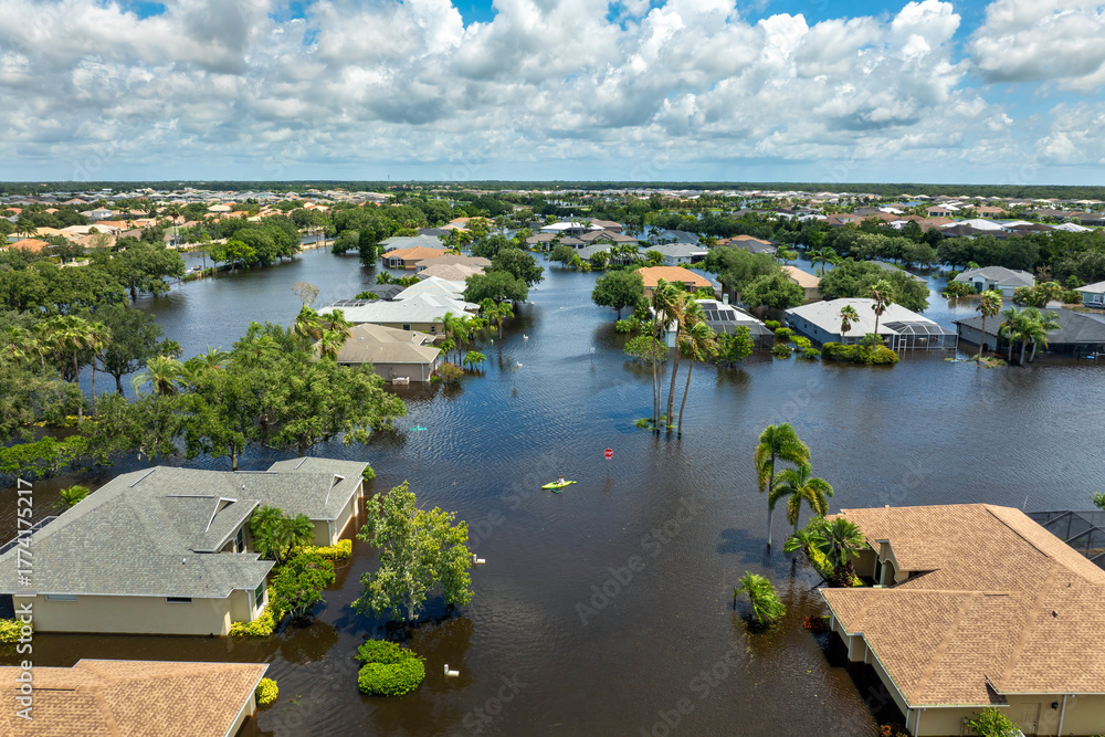 Obraz premium Flooded residential area with underwater houses from hurricane rainfall water in Florida suburban community. Aftermath of natural disaster in southern USA