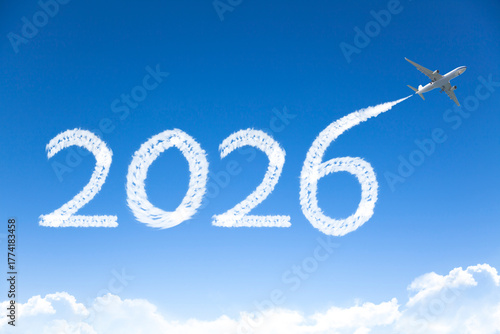 Happy New year 2026 concept travel on the background below cloudscape. Drawing by passenger airplane vapor contrail in sky.
