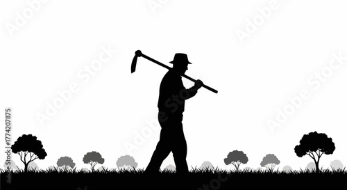 Silhouette of a farmer walking with a hoe on his shoulder.