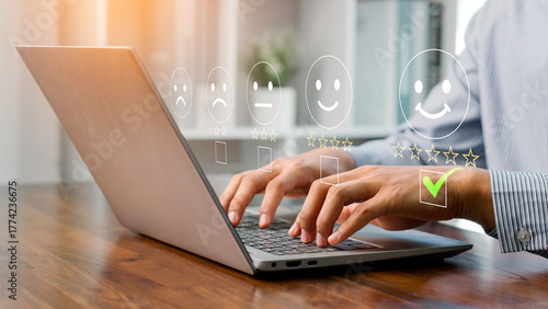A person using a laptop to rate customer satisfaction with five-star feedback, showing online service quality, user experience, digital communication, and business review for marketing and improvement