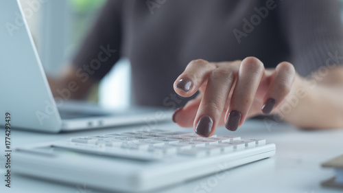 Business woman using calculator to calculate financial report, bookkeeping payroll and budget tax. Business, finance and investment, budget and tax calculation and planning